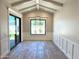 Bright dining room with modern chandelier, wainscoting, and backyard views through large window at 3021 N 47Th St, Phoenix, AZ 85018