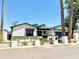 Attractive home with black trim, new landscaping and front yard hardscape, complimented by the clear blue sky at 3021 N 47Th St, Phoenix, AZ 85018