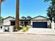 Charming single-story home with an attached garage, new landscaping and a view of the blue sky above at 3021 N 47Th St, Phoenix, AZ 85018