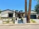 Charming home with an inviting front yard, black trimmed windows and a driveway leading to an attached garage at 3021 N 47Th St, Phoenix, AZ 85018