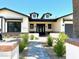 An inviting home exterior featuring stylish landscaping, a brick pathway, and dormer windows at 3021 N 47Th St, Phoenix, AZ 85018