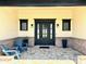 Inviting front entryway featuring a stylish door, brick accents, a paved porch, and comfortable seating at 3021 N 47Th St, Phoenix, AZ 85018