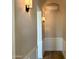 Hallway with sconce lighting and white wainscoting gives off a warm and inviting atmosphere at 3021 N 47Th St, Phoenix, AZ 85018