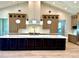 Spacious kitchen island featuring a stone countertop and modern pendant lighting at 3021 N 47Th St, Phoenix, AZ 85018