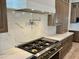 A chef's dream kitchen with stainless steel range, custom hood, and premium countertops at 3021 N 47Th St, Phoenix, AZ 85018