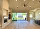 Bright living room with hardwood floors, a stone fireplace, and sliding glass doors leading to the outdoor space at 3021 N 47Th St, Phoenix, AZ 85018