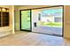 Bright living room featuring hardwood floors, a built-in bookshelf, and sliding glass doors to the backyard at 3021 N 47Th St, Phoenix, AZ 85018