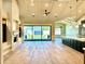 Open-concept living room features hardwood floors, a stone fireplace, and large sliding doors to the backyard at 3021 N 47Th St, Phoenix, AZ 85018