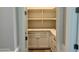 Walk-in pantry offers generous storage with custom shelves, cabinets, and stone countertop at 3021 N 47Th St, Phoenix, AZ 85018
