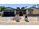 Charming single-Gathering home with a garage and unique architectural details under a clear blue sky at 3028 N 47Th St, Phoenix, AZ 85018