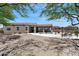 Expansive backyard featuring a swimming pool, covered patio, and desert landscape, perfect for relaxation and entertaining at 31825 N 141St St, Scottsdale, AZ 85262