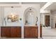 Well-appointed bar area with granite countertop, rich cabinetry, and modern lighting at 31825 N 141St St, Scottsdale, AZ 85262