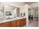 Primary bathroom with dual vanities, granite counters and mirrors, and views of the surrounding desert landscape at 31825 N 141St St, Scottsdale, AZ 85262