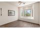Clean and spacious bedroom featuring a bright window nook overlooking green trees and desert landscape at 31825 N 141St St, Scottsdale, AZ 85262