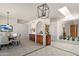 Elegant dining area with stylish chandelier, arched doorway, and built-in cabinetry at 31825 N 141St St, Scottsdale, AZ 85262