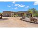 Desert home with drought-resistant landscaping featuring cacti, succulents, and a winding driveway at 31825 N 141St St, Scottsdale, AZ 85262