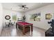 Bright game room offers a pool table and natural light, perfect for leisure and recreation at 31825 N 141St St, Scottsdale, AZ 85262