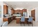 Bright and functional kitchen with wood cabinets, stainless steel appliances, and breakfast bar at 31825 N 141St St, Scottsdale, AZ 85262
