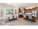 Well-lit eat-in kitchen with stainless steel appliances, island, and wood cabinetry at 31825 N 141St St, Scottsdale, AZ 85262