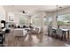 Open-concept living room and dining area with fireplace, natural light, and modern furniture at 31825 N 141St St, Scottsdale, AZ 85262