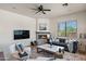 Inviting living room features a cozy fireplace and comfortable seating, perfect for relaxation at 31825 N 141St St, Scottsdale, AZ 85262