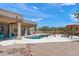 Inviting backyard with a sparkling pool, desert landscaping, and shaded patio area for relaxing and enjoying the outdoors at 31825 N 141St St, Scottsdale, AZ 85262