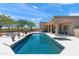Luxurious pool and spa area featuring manicured landscaping, covered patio, and lounge chairs at 31825 N 141St St, Scottsdale, AZ 85262