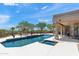 Stunning backyard oasis with a sparkling pool, spa, desert landscaping, and a shaded pergola for relaxing outdoors at 31825 N 141St St, Scottsdale, AZ 85262