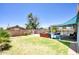 Spacious backyard with a well-maintained lawn, a barbecue area, and a shaded patio area near the refreshing pool at 3203 W Libby St, Phoenix, AZ 85053
