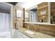 Charming bathroom with granite countertops, wood tile accents, and decorative mirror at 3203 W Libby St, Phoenix, AZ 85053