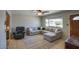 Comfortable living room with a large window, ceiling fan, and plush seating arrangement at 3203 W Libby St, Phoenix, AZ 85053