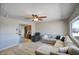 Inviting living room featuring tile floors, a ceiling fan, and a comfortable sectional sofa at 3203 W Libby St, Phoenix, AZ 85053