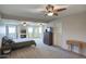Large main bedroom with three ceiling fans, neutral carpet, walk out doors, and ample space at 3203 W Libby St, Phoenix, AZ 85053