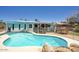 View of the pool in backyard with sunshade and safety fence in a well-kept outdoor space at 3203 W Libby St, Phoenix, AZ 85053
