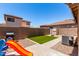 A well-kept backyard featuring a small square of artificial turf for recreational use at 3438 S Bowman Rd, Apache Junction, AZ 85119