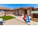 An enclosed backyard featuring gravel landscaping, a small patch of artificial grass, and play equipment at 3438 S Bowman Rd, Apache Junction, AZ 85119
