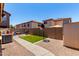 A spacious backyard features gravel landscaping, artificial grass, and block wall at 3438 S Bowman Rd, Apache Junction, AZ 85119