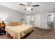 Spacious bedroom showcasing a ceiling fan and ensuite bathroom, offering a tranquil retreat at 3438 S Bowman Rd, Apache Junction, AZ 85119