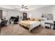 Comfortable bedroom features a ceiling fan, workspace, shelving, and plentiful natural light at 3438 S Bowman Rd, Apache Junction, AZ 85119