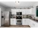 Bright kitchen with stainless steel appliances, granite countertops, and modern white cabinets at 3438 S Bowman Rd, Apache Junction, AZ 85119