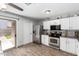 Bright kitchen featuring stainless steel appliances and an adjacent door leading to the backyard at 3438 S Bowman Rd, Apache Junction, AZ 85119