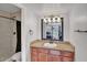 Well-lit bathroom with updated vanity, a framed mirror, and a walk-in shower with a neutral shower curtain at 3500 N Hayden Rd # 203, Scottsdale, AZ 85251