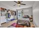 Bedroom with an open closet, ceiling fan, and plush area rug, creating a comfortable and organized space at 3500 N Hayden Rd # 203, Scottsdale, AZ 85251