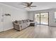 Cozy living room featuring modern ceiling fan, sliding glass doors, and gray sofa at 3500 N Hayden Rd # 203, Scottsdale, AZ 85251