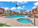 Community pool and spa, complete with poolside seating, palm trees, and well-maintained landscaping at 3500 N Hayden Rd # 203, Scottsdale, AZ 85251