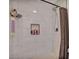 The modern tiled shower includes a recessed niche, rainfall shower head and neutral curtain rod at 3500 N Hayden Rd # 203, Scottsdale, AZ 85251