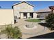 The backyard features a stone fire pit, gravel landscaping, and a small patch of artificial turf at 3810 N 106Th Dr, Avondale, AZ 85392