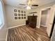Bedroom with wood-look flooring, built-in desk, and a ceiling fan offers comfort and style at 3810 N 106Th Dr, Avondale, AZ 85392