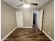 This bedroom features wood flooring and a ceiling fan at 3810 N 106Th Dr, Avondale, AZ 85392