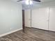 Spacious room with wood-look floors, access to the bedroom's closet and en suite bath from the hallway at 3810 N 106Th Dr, Avondale, AZ 85392